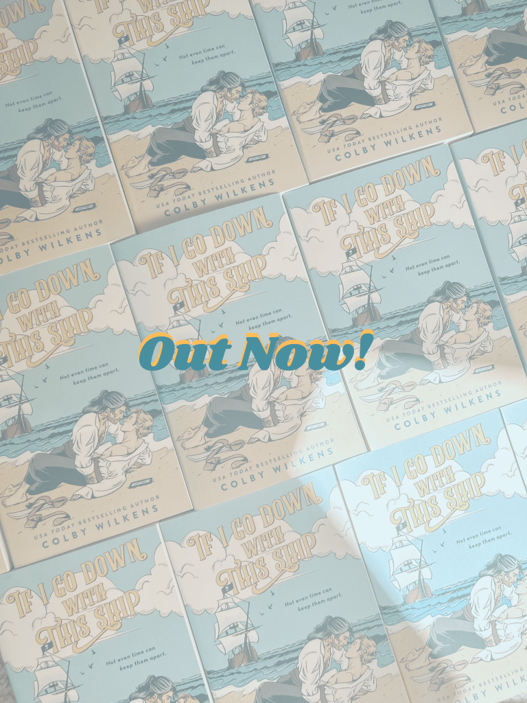 Out Now letters over a slightly greyed out image of several copies of If I Go Down With This Ship laid out. Book cover of If I Go Down With This Ship in the center with two pirates in the sand, one with blakc and pepper hair leaning down as if to kiss a blonde one in the sand with the tide ocming toward them and a pirate ship anchored in the bay. USA Today bestselling Author Colby wilkens at the bottom
